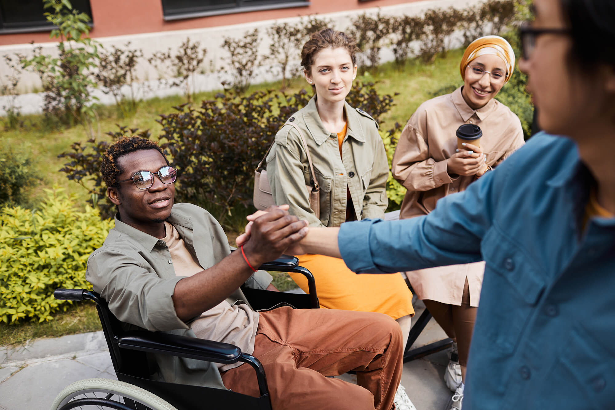 making-handshake-with-man-in-wheelchair-2023-11-27-04-51-53-utc.jpg